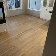 Carpet was removed from the center of the dining room. The space was then filled in on a 45 with a walnut / maple border and a walnut, oak and maple inlay. Oak was stained with Latte Macchiato with a satin finish on top.