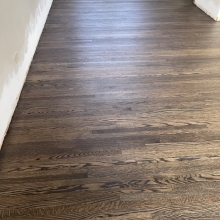 Original floor - red oak, closet in one bedroom did not have hardwood. Patched in the missing wood, and the sanded everything and finished it with a custom Bona 2K craft oil blend. 
