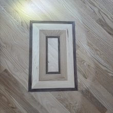 Carpet was removed from the center of the dining room. The space was then filled in on a 45 with a walnut / maple border and a walnut, oak and maple inlay. Oak was stained with Latte Macchiato with a satin finish on top.